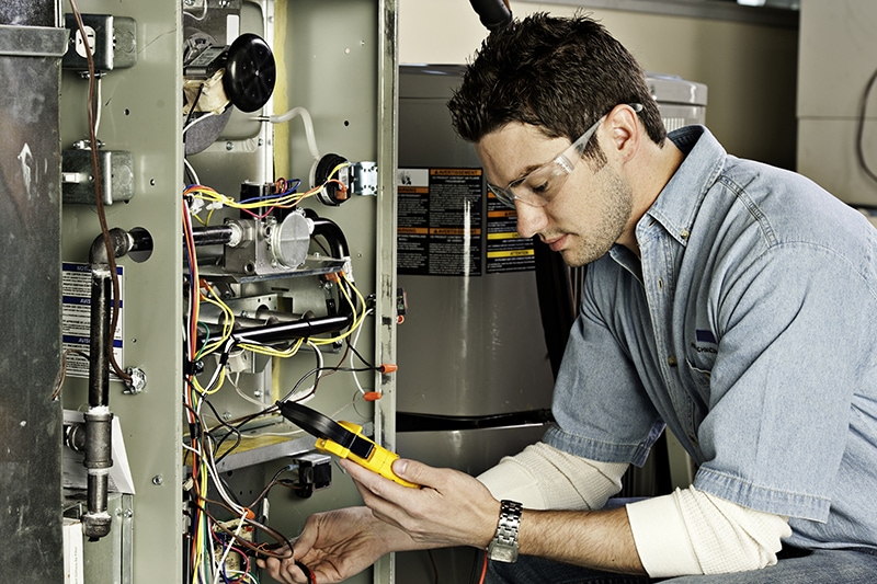 Service technician testing a furnace.