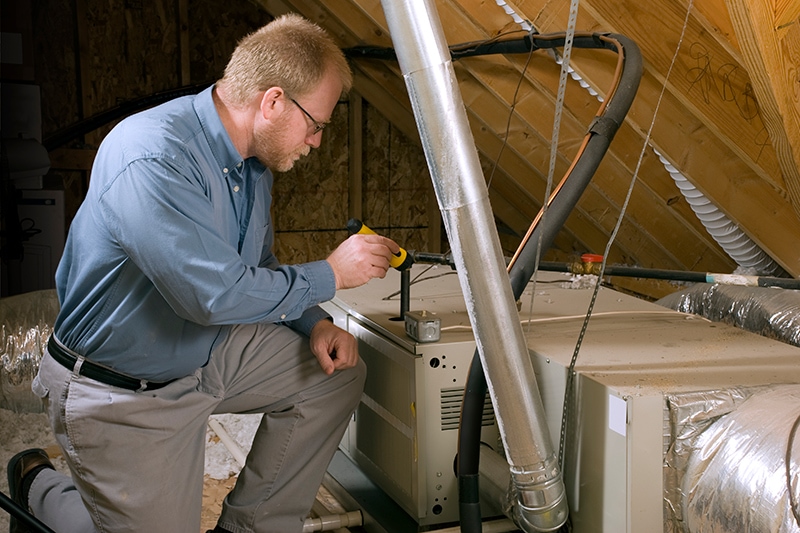 How Do I Know When I Need a New Furnace? - Man Repairing Furnace.