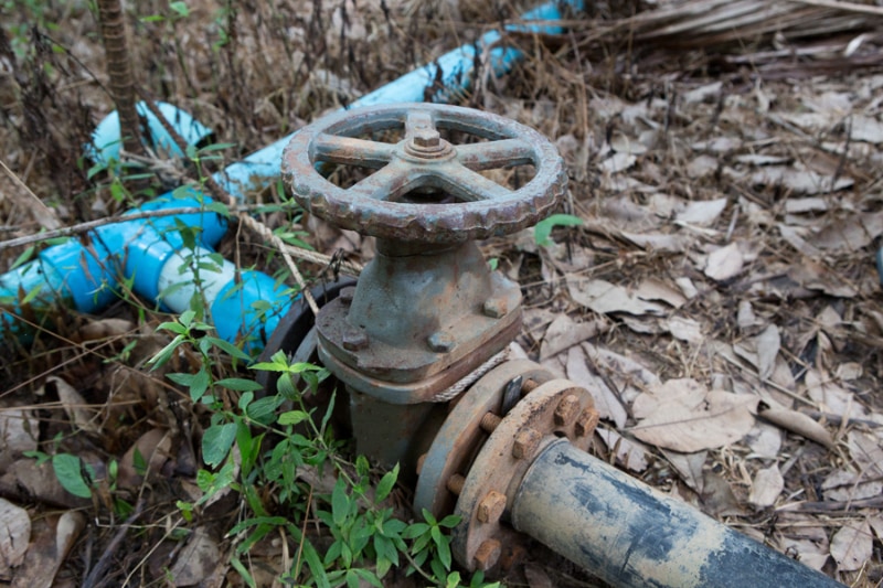 What to Do If Your Main Line Drain Is Clogged. The water valve on the pipe in farm.