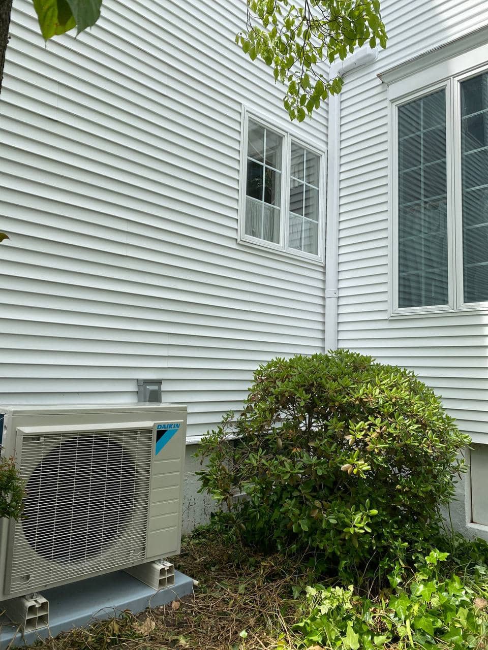 Outdoor ductless unit next to a house.